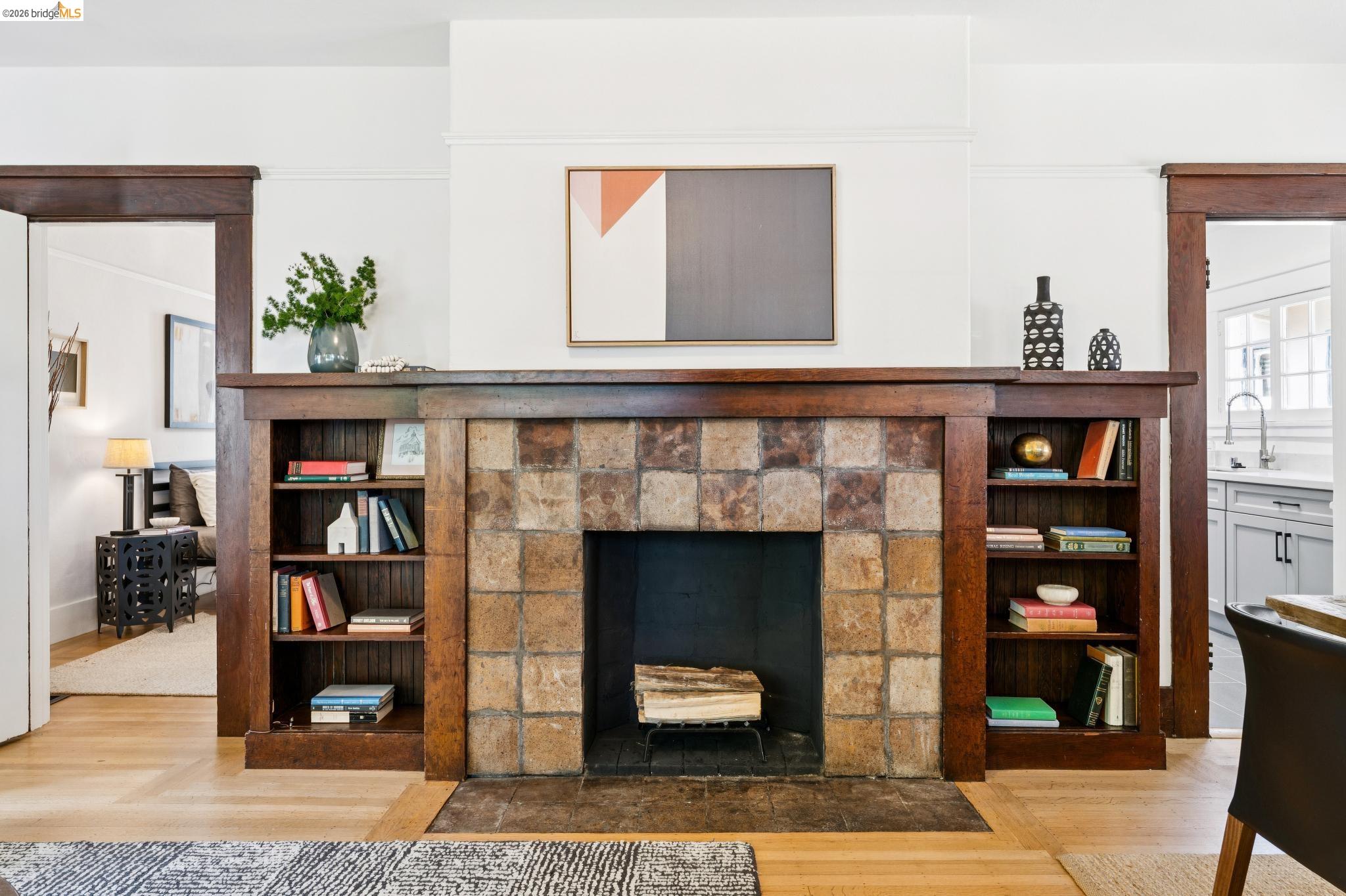 2320 Derby Street Berkeley, CA 94705 - Photo 9 of 39 a living room with fireplace and a book shelf