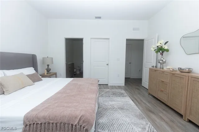 a bedroom with a bed and a dresser