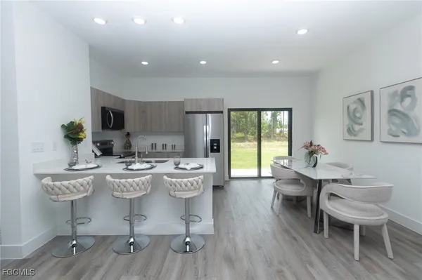 a view of a dining room with furniture and wooden floor