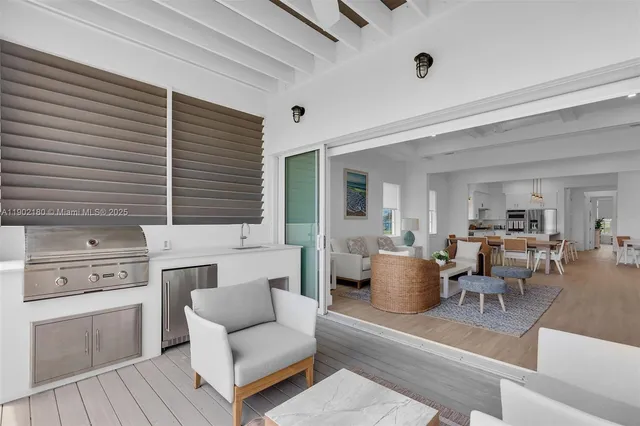 a living room with couches and a dining table with wooden floor