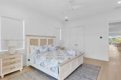 a view of a bedroom with cabinets and window