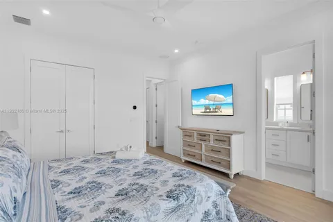 a bedroom with a bed and a large window with outer view