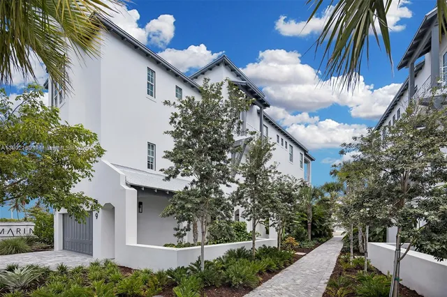 a view of a house with a tree and plants