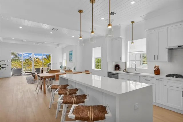 a large kitchen with a table and chairs