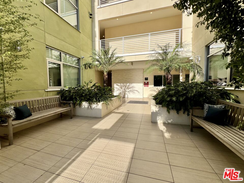 11715 Bellagio Road, Unit 204 Los Angeles, CA 90049 - Photo 20 of 27 a view of a chairs and table in a patio
