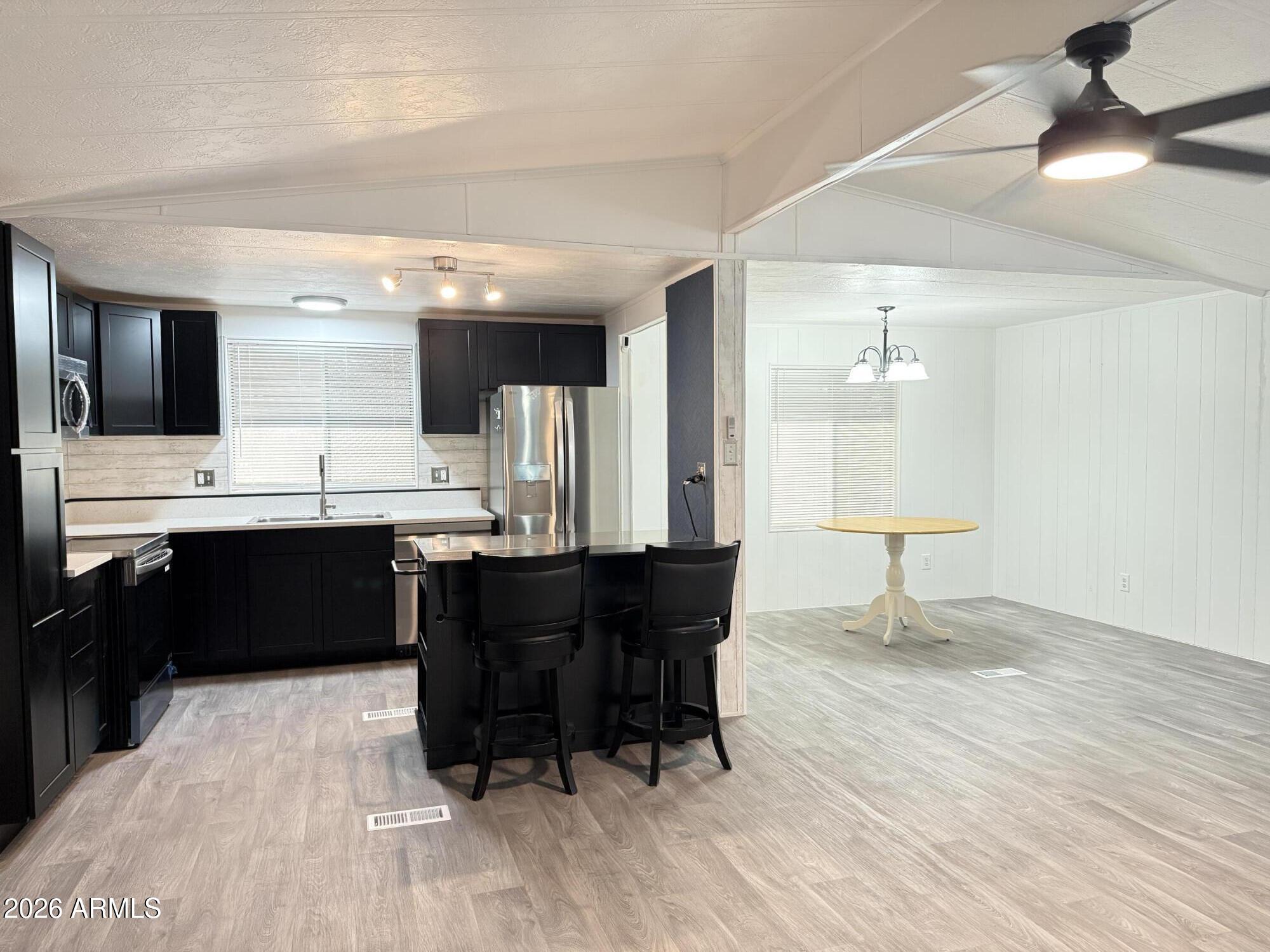 535 South Alma School Road, Unit 113 Mesa, AZ 85210 - Photo 5 of 41 a large kitchen with a table and chairs