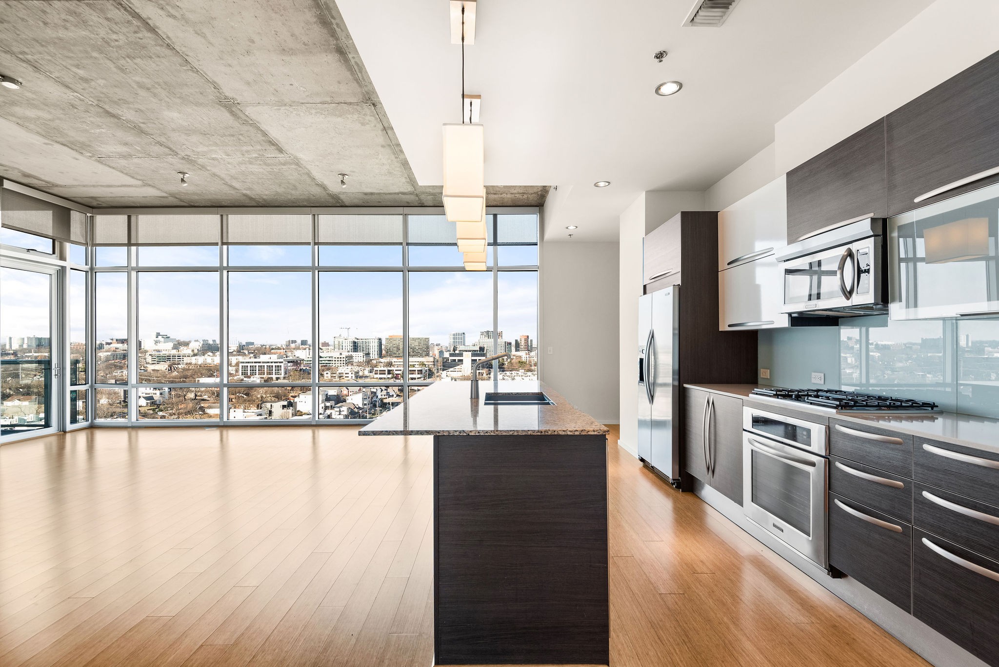 a kitchen with stainless steel appliances granite countertop a stove and wooden floor