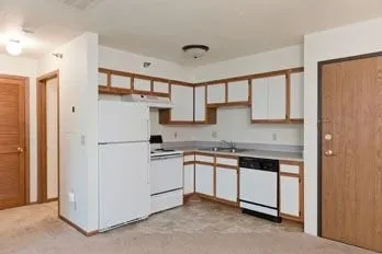 a kitchen with stainless steel appliances granite countertop a refrigerator sink and cabinets