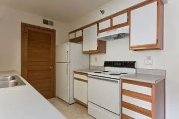a kitchen with a sink stove and refrigerator