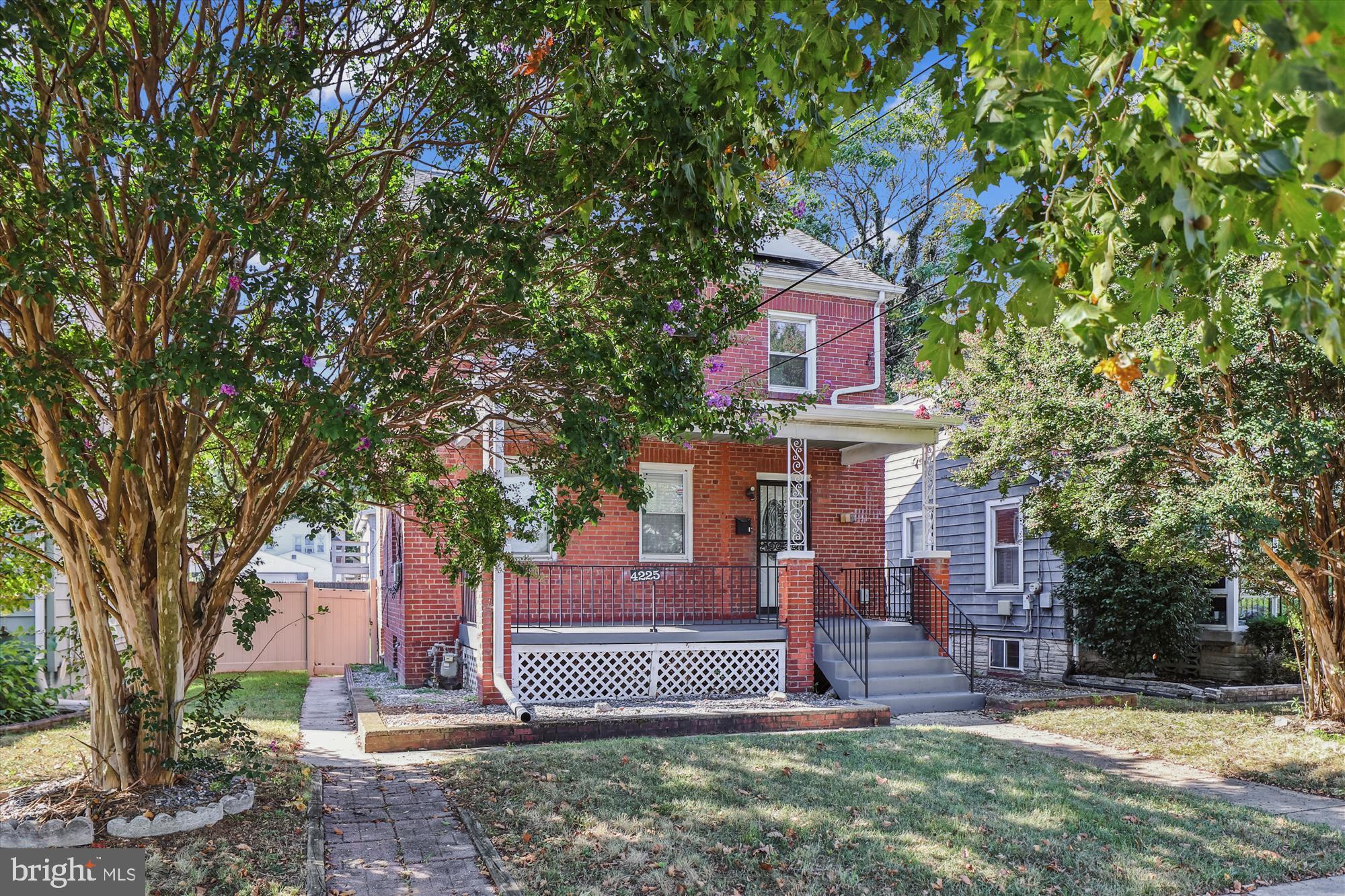 4225 Meade Street Northeast Washington, DC 20019 - Photo 1 of 42 Charming brick home with lush greenery.