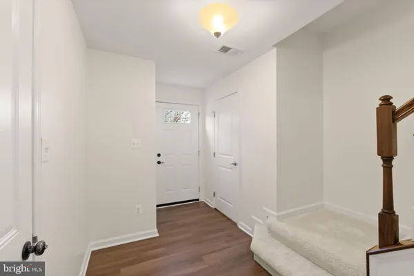 a kitchen with stainless steel appliances granite countertop a refrigerator a sink dishwasher a stove and a wooden floors