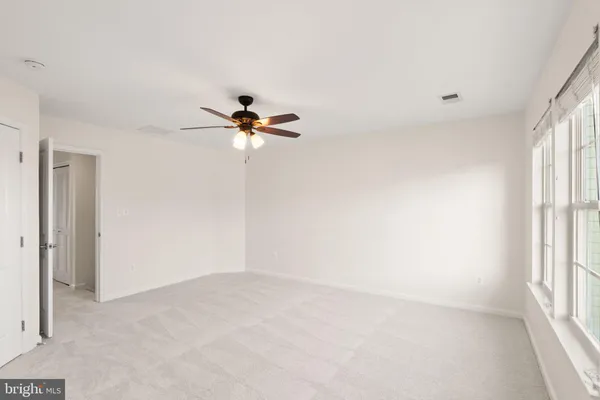 a view of a hallway with wooden floor and entryway