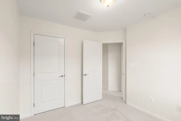a view of a house with wooden deck and furniture