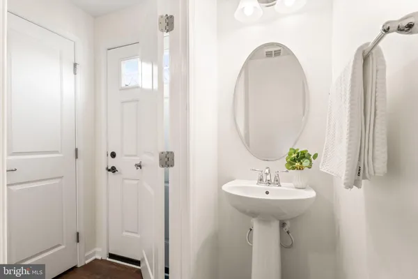 a view of wooden house with a yard and large trees