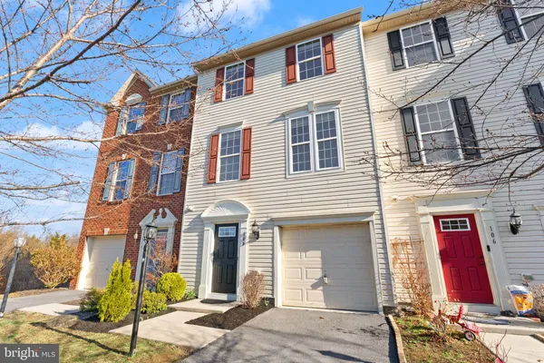 a view of a brick house with potted plants