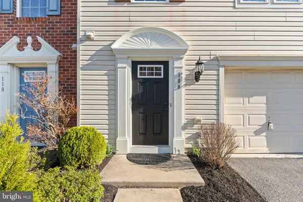 a view of a kitchen with wooden floor and a refrigerator