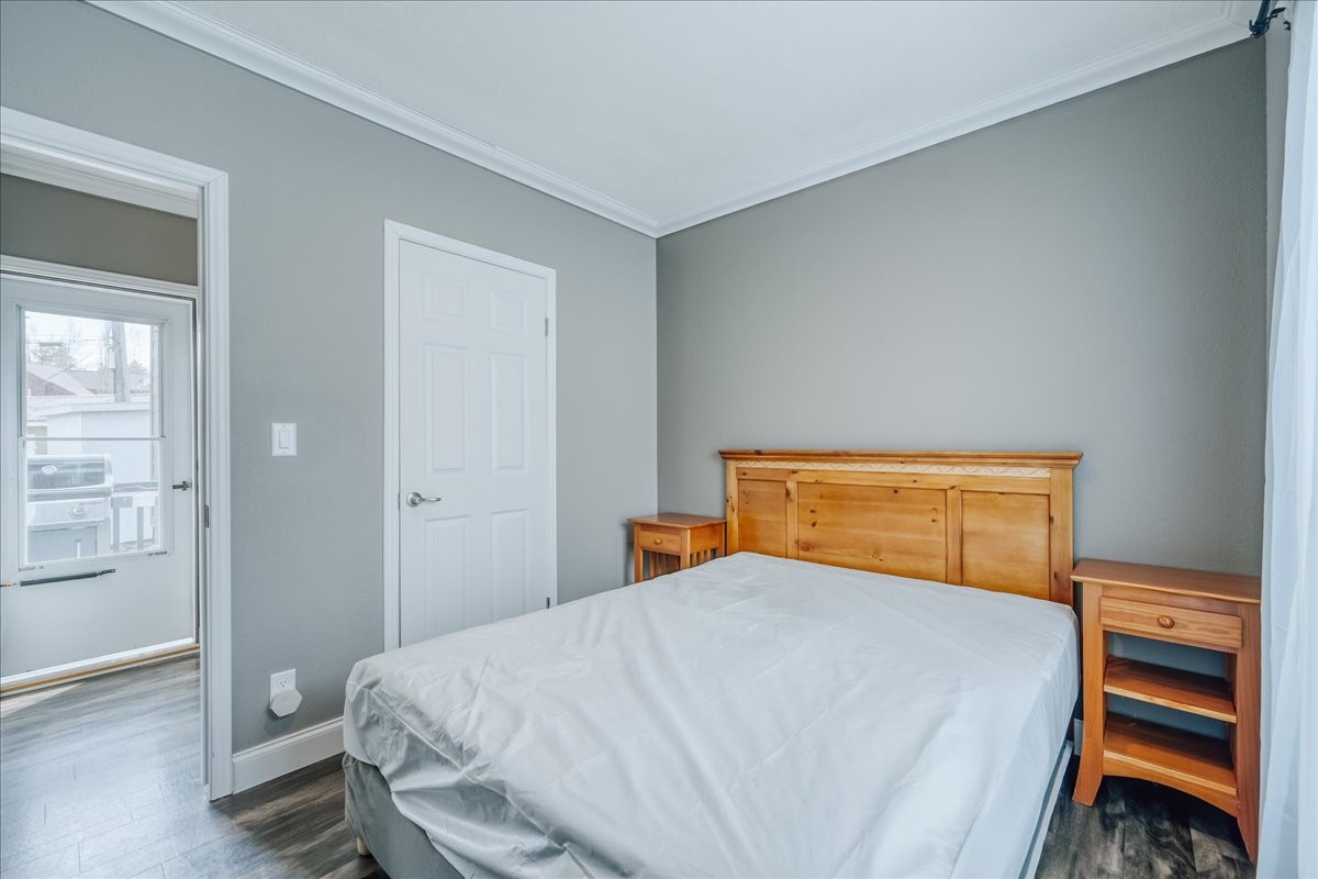 847 Airport Road, Unit 21 Breckenridge, CO 80424 - Photo 18 of 35 a bedroom with a bed and wooden floor