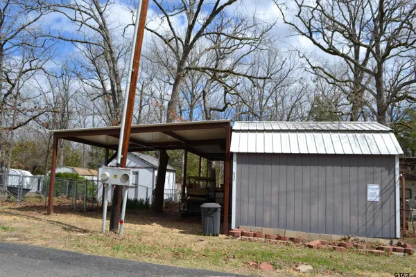 a view of a house with a yard and wooden fence