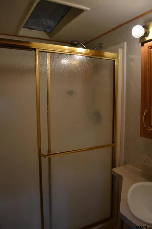 a bathroom with a glass shower door