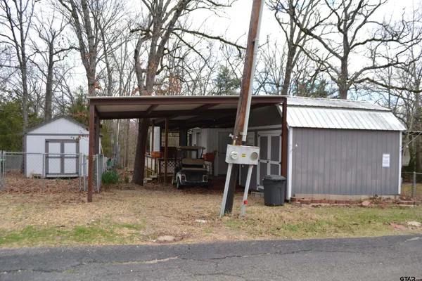 a view of a house with a snow and a large tree