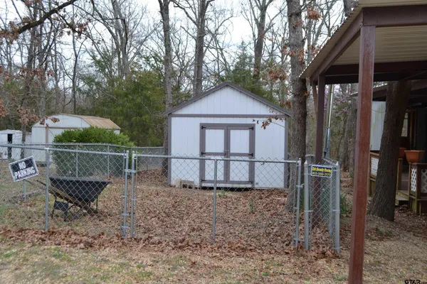 a backyard of a house with barbeque oven and outdoor seating