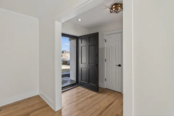a view of hallway with wooden floor