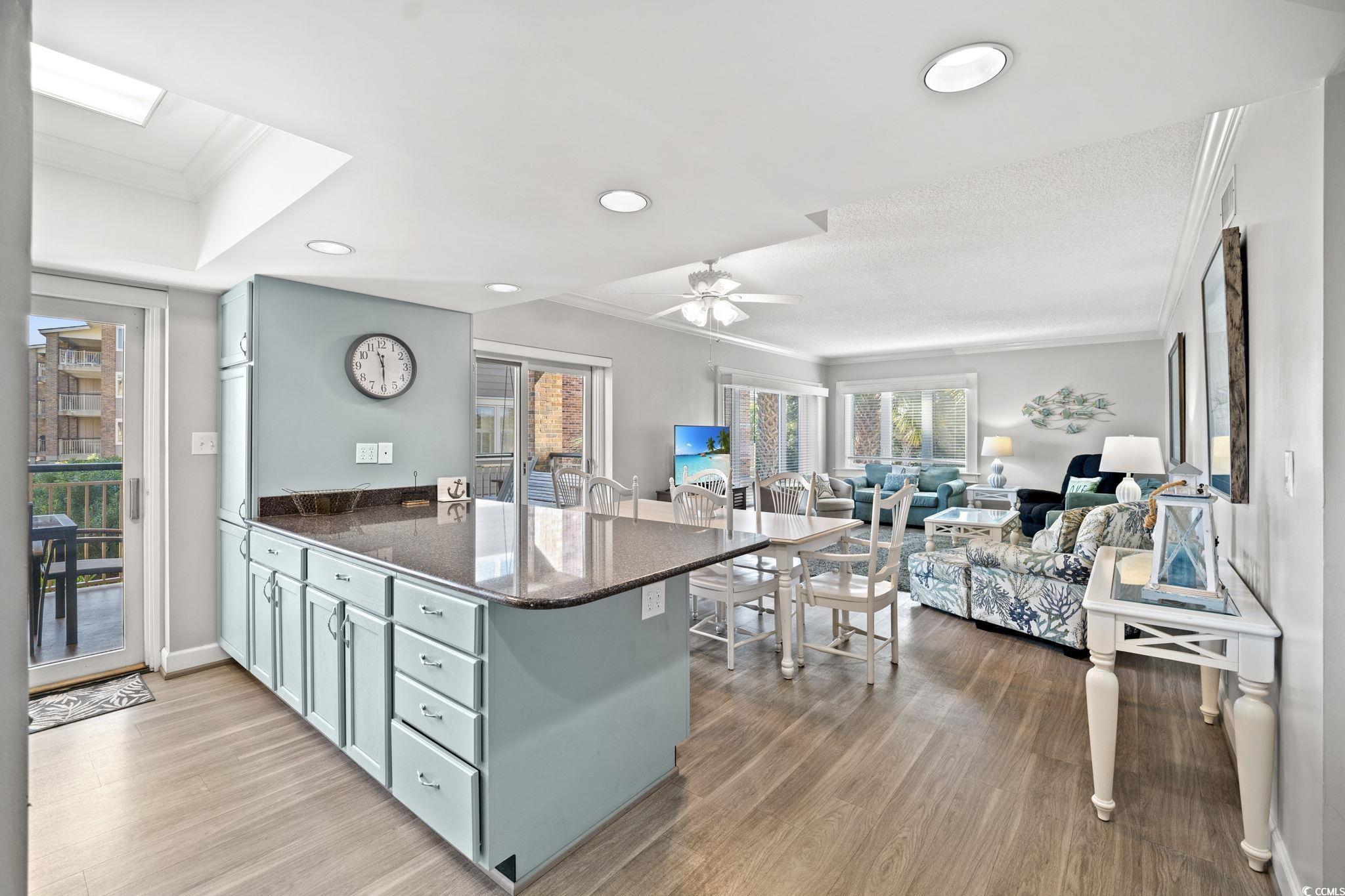 320 Myrtle Avenue Pawleys Island, SC 29585 - Photo 18 of 38 Kitchen featuring ornamental molding, dark stone counters, dark wood-style flooring, a peninsula, and recessed lighting