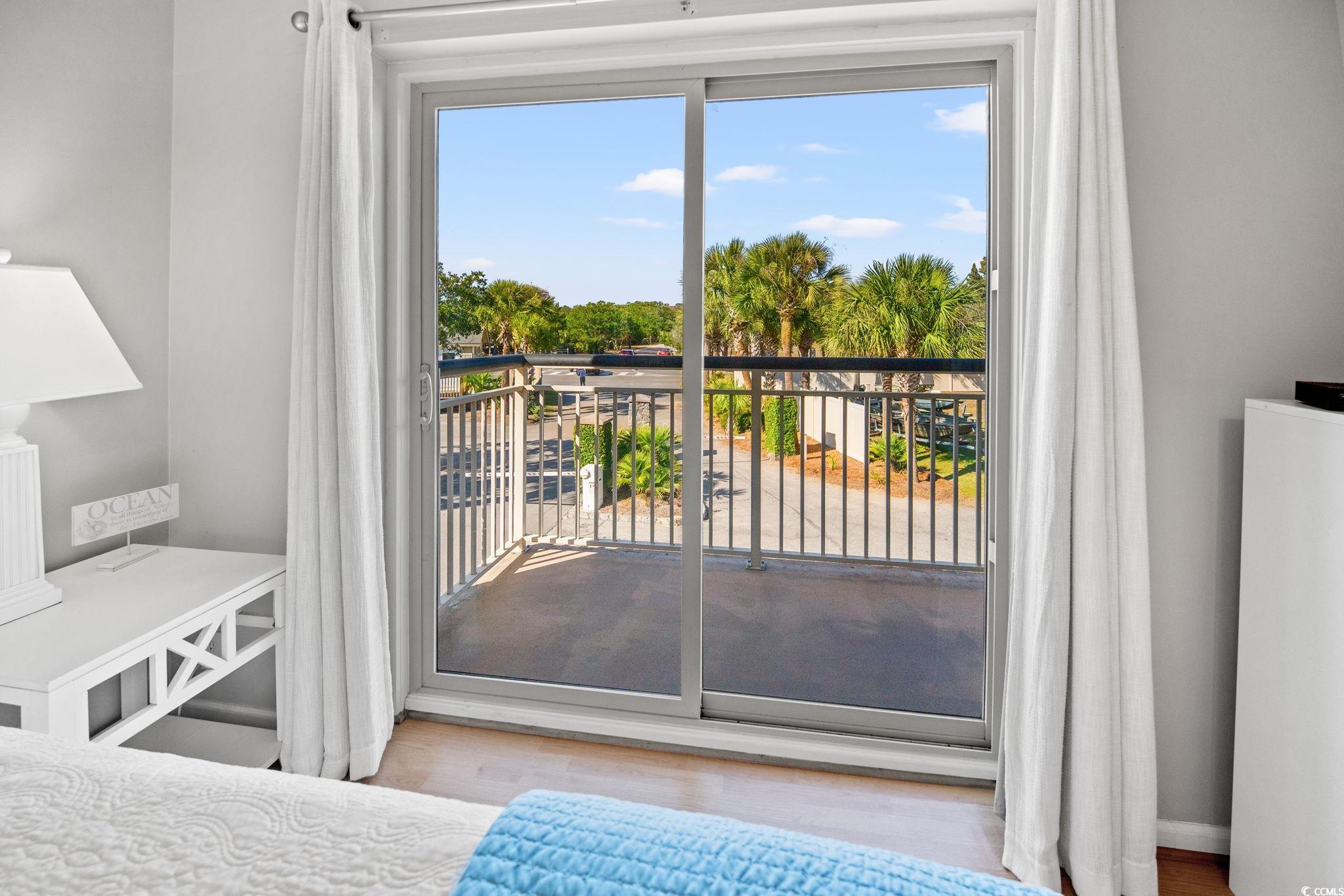 320 Myrtle Avenue Pawleys Island, SC 29585 - Photo 24 of 38 Bedroom featuring light wood-style floors and access to outside