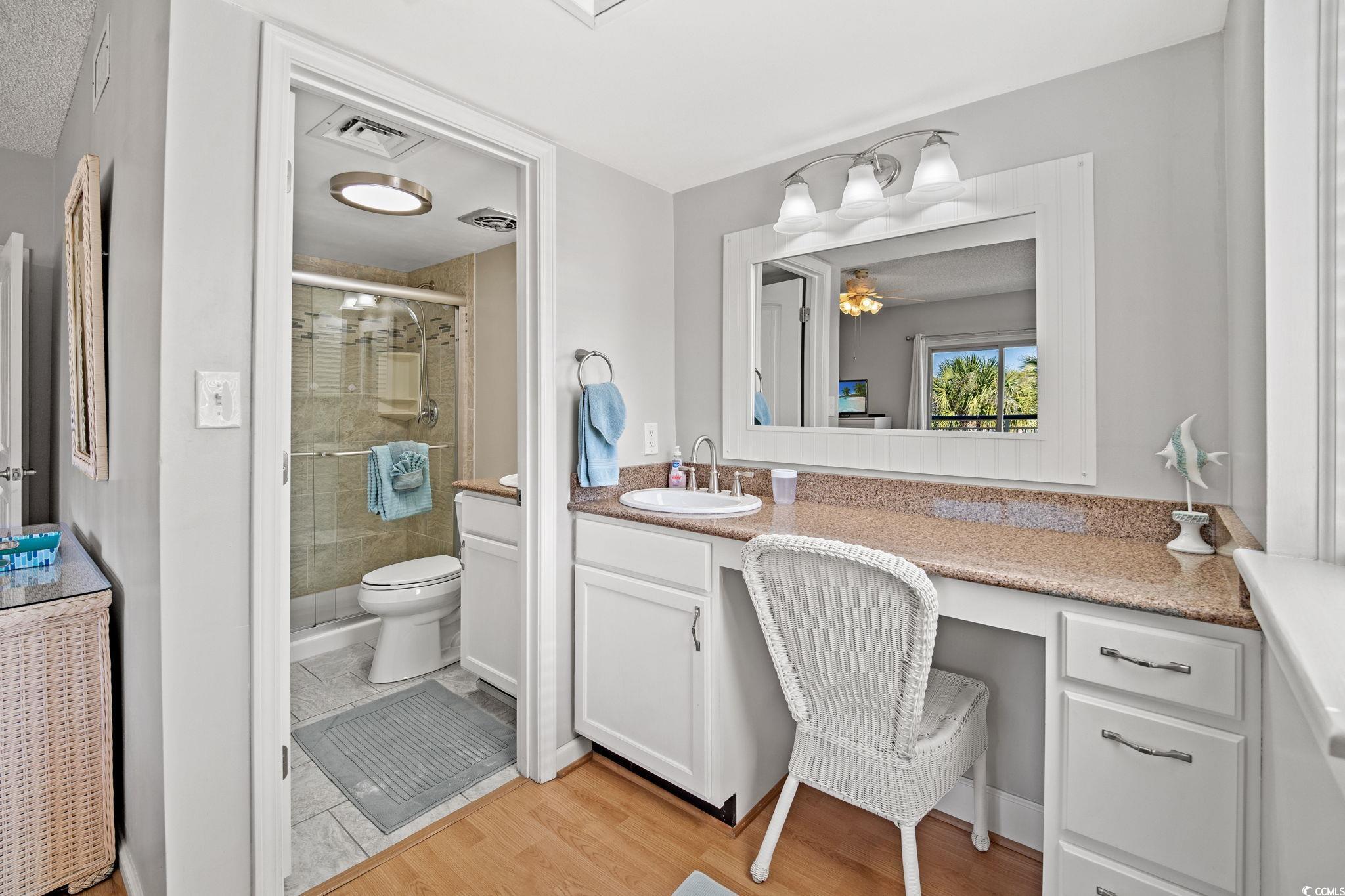 320 Myrtle Avenue Pawleys Island, SC 29585 - Photo 25 of 38 Full bath with vanity, a stall shower, and light wood-type flooring