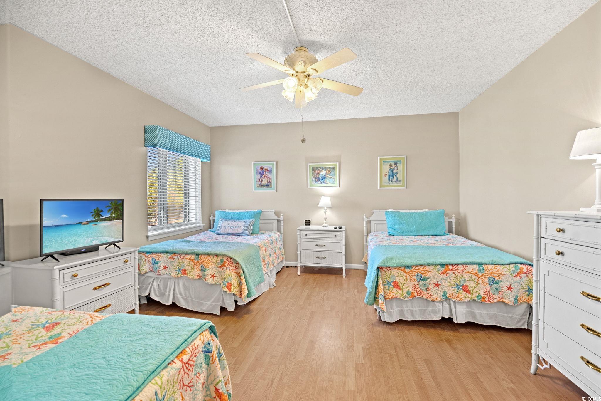 320 Myrtle Avenue Pawleys Island, SC 29585 - Photo 27 of 38 Bedroom with light wood finished floors, a textured ceiling, and ceiling fan