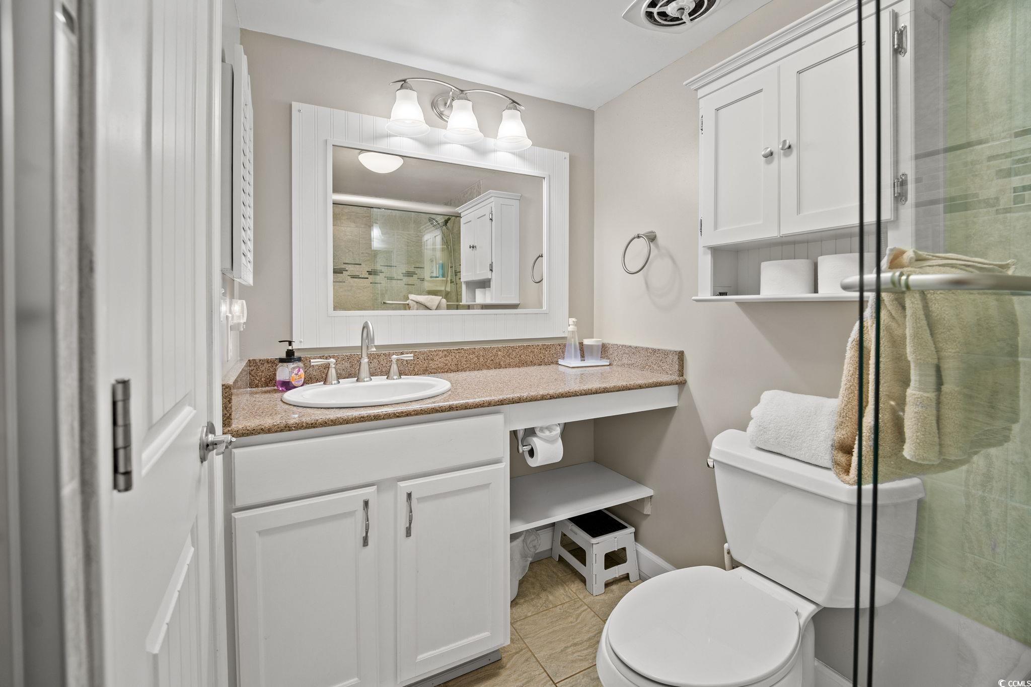 320 Myrtle Avenue Pawleys Island, SC 29585 - Photo 28 of 38 Bathroom featuring a shower stall, vanity, and light tile patterned flooring