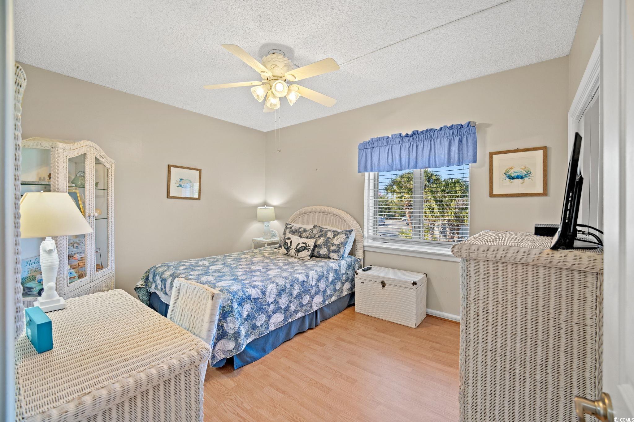 320 Myrtle Avenue Pawleys Island, SC 29585 - Photo 31 of 38 Bedroom featuring a textured ceiling, wood finished floors, and ceiling fan
