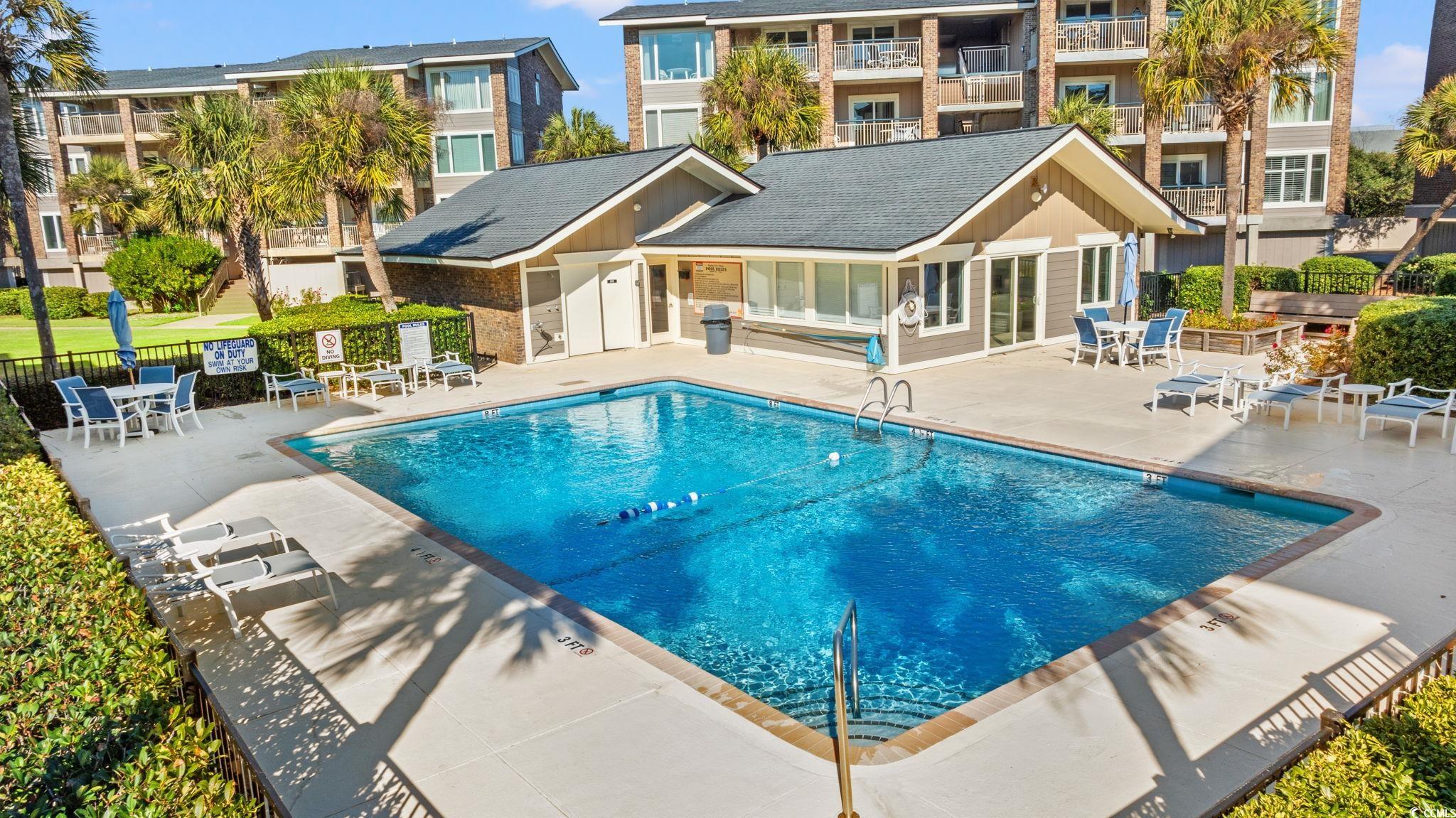 320 Myrtle Avenue Pawleys Island, SC 29585 - Photo 10 of 38 Community pool featuring a patio area and outdoor dining area