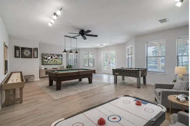 a living room with furniture and a wooden floor