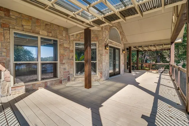 a view of a porch with a table and chairs