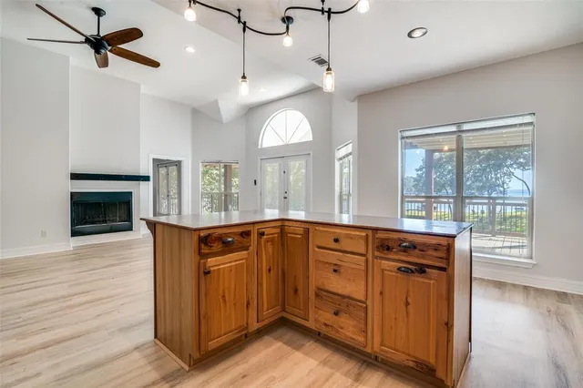a open kitchen with stainless steel appliances granite countertop a stove cabinets and wooden floor