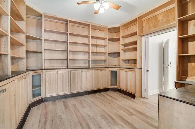 a view of a hardwood floor and windows in a room
