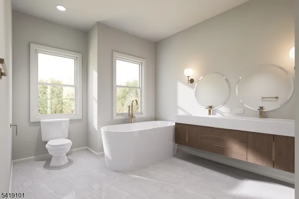 a view of a big room with windows and chandelier fan