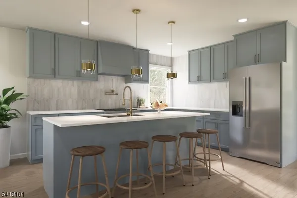 a kitchen with stainless steel appliances granite countertop a sink a stove a refrigerator and a counter top space