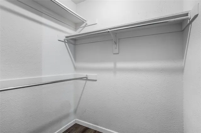 a bathroom with a sink double vanity granite and a shower