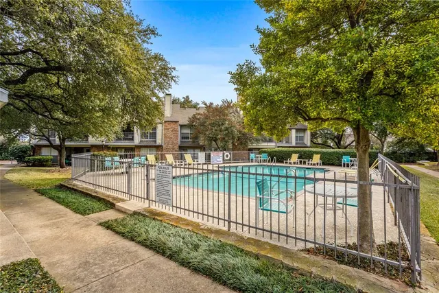 swimming pool view with a seating space and a garden view
