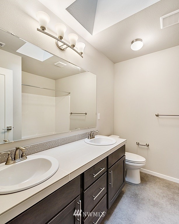130 180th Place Southwest, Unit CT 03 Bothell, WA 98012 - Photo 14 of 20 a bathroom with a sink a toilet and a mirror
