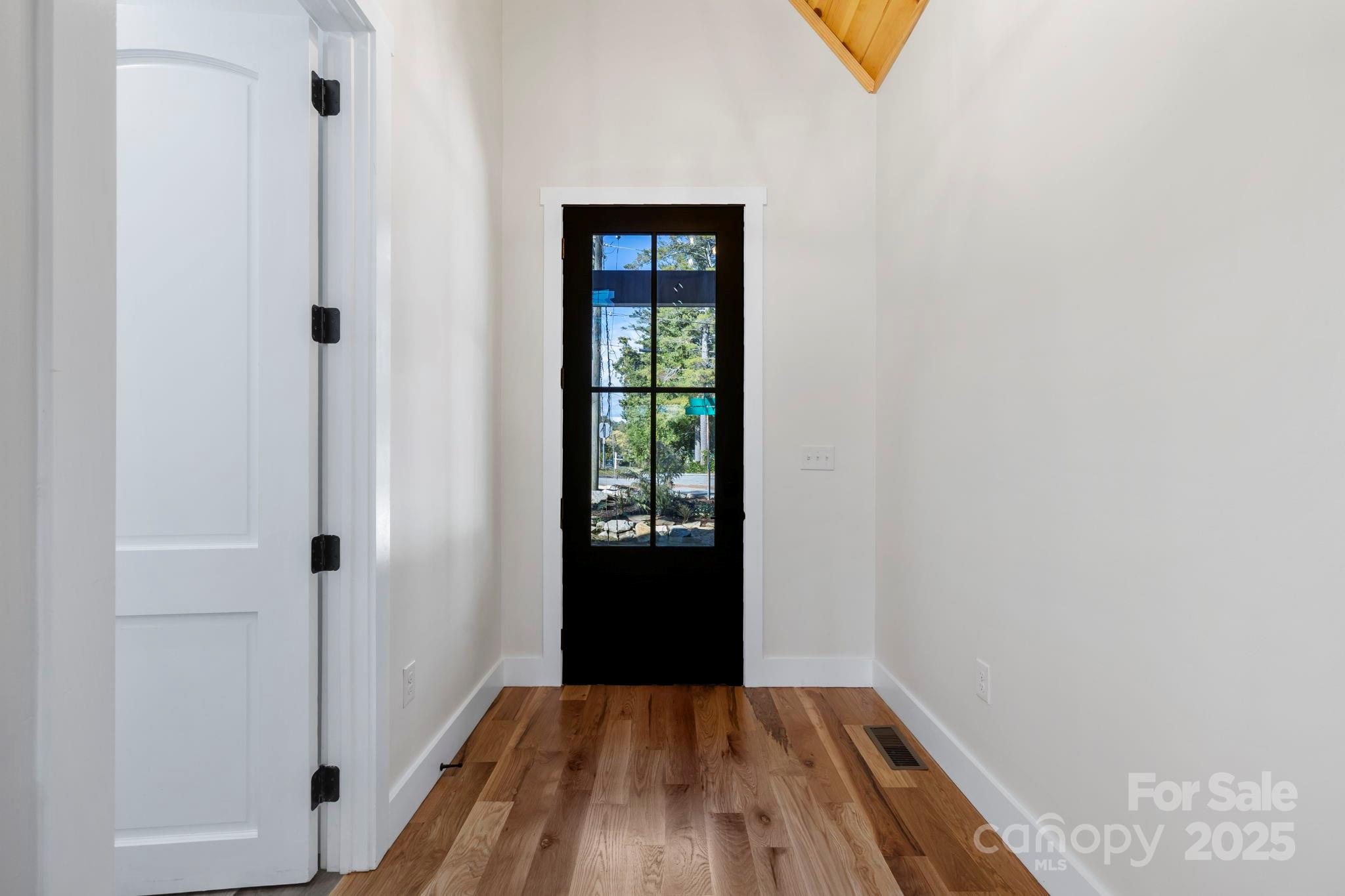 154 Osceola Road Hendersonville, NC 28739 - Photo 11 of 38 a view of a bedroom with wooden floor and entryway