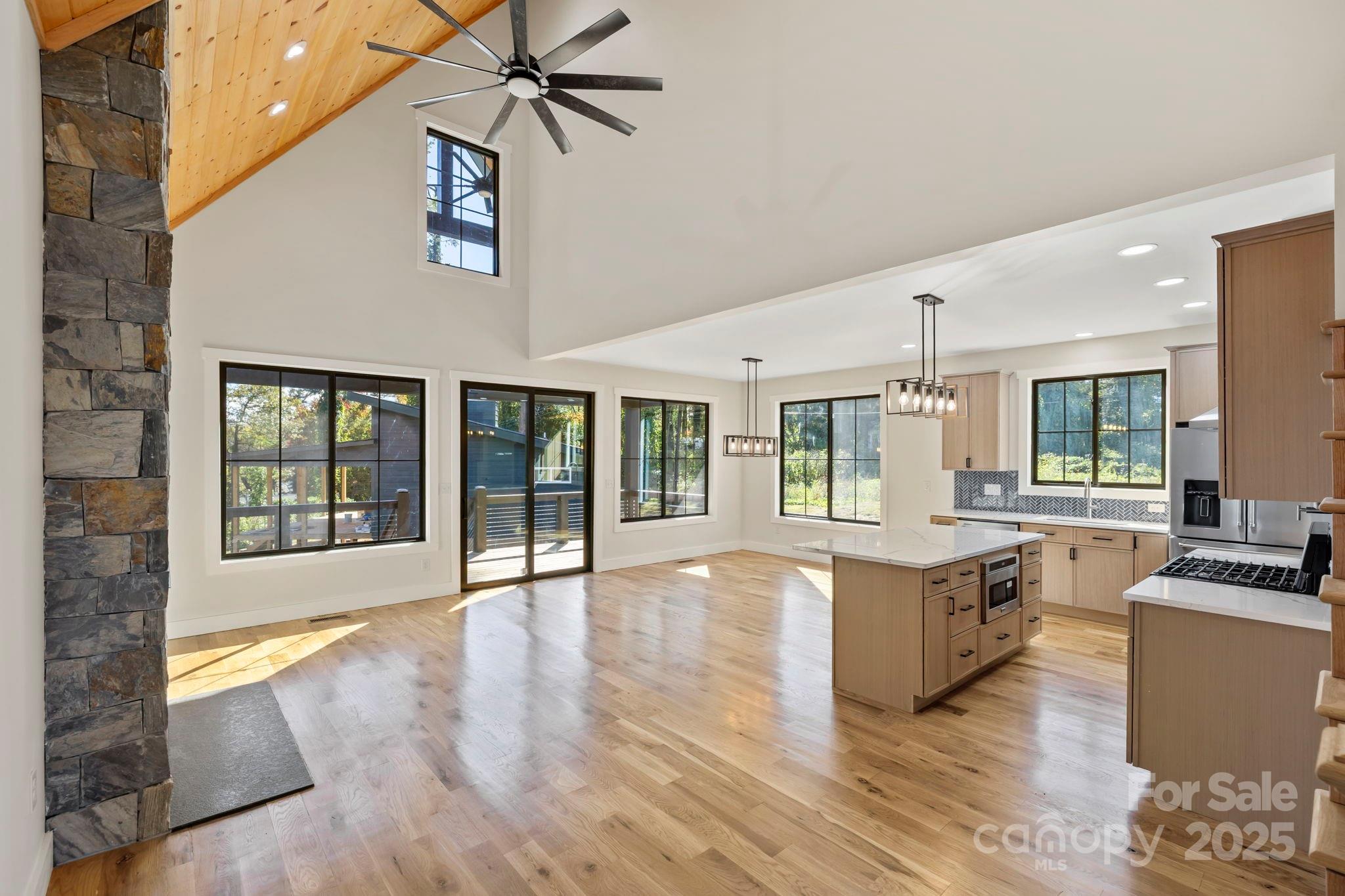 154 Osceola Road Hendersonville, NC 28739 - Photo 13 of 38 a view of living room with furniture and floor to ceiling window