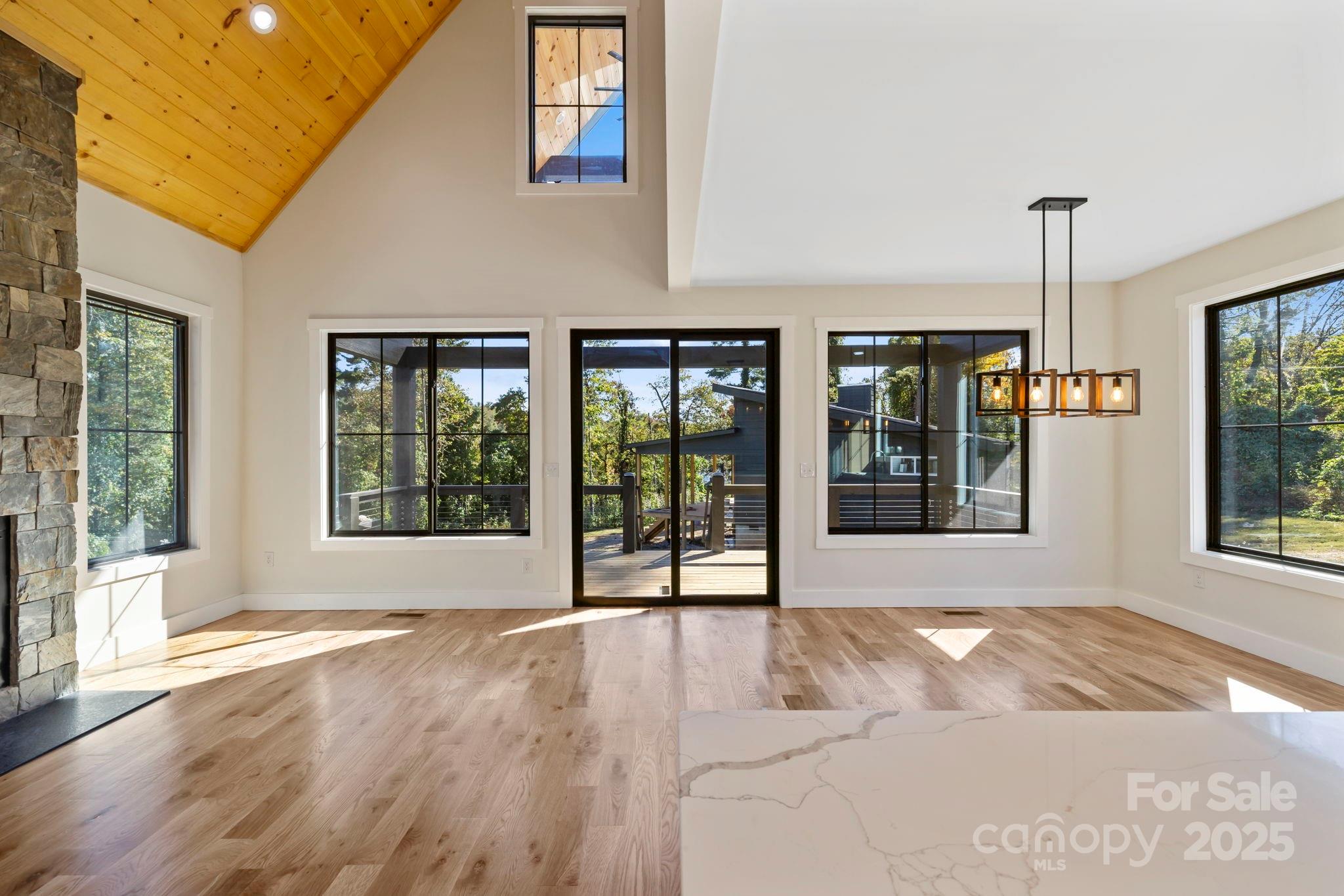 154 Osceola Road Hendersonville, NC 28739 - Photo 14 of 38 a view of an empty room with window and wooden floor
