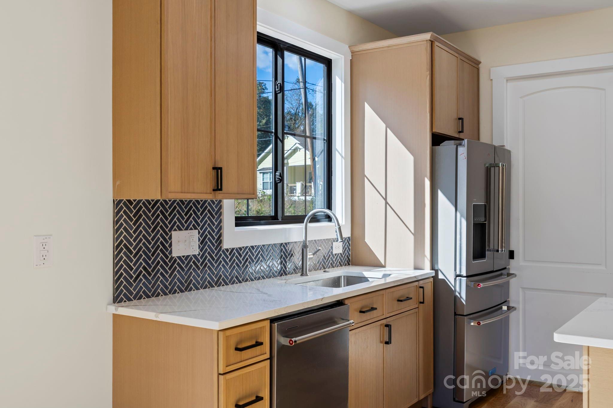 154 Osceola Road Hendersonville, NC 28739 - Photo 20 of 38 a kitchen with stainless steel appliances a sink and a refrigerator