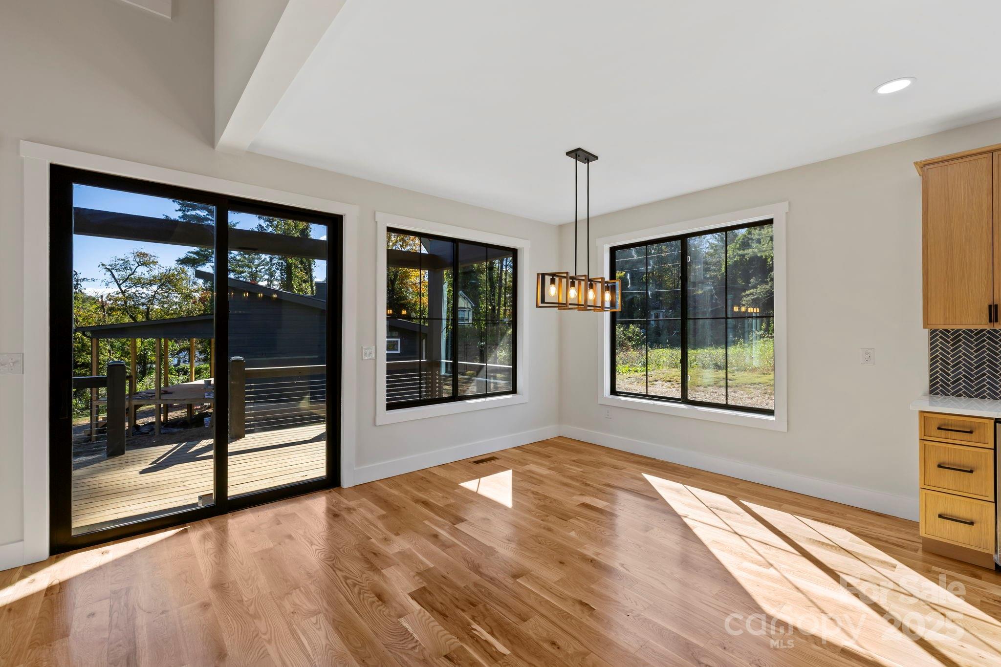 154 Osceola Road Hendersonville, NC 28739 - Photo 22 of 38 a view of an empty room with a window and wooden floor