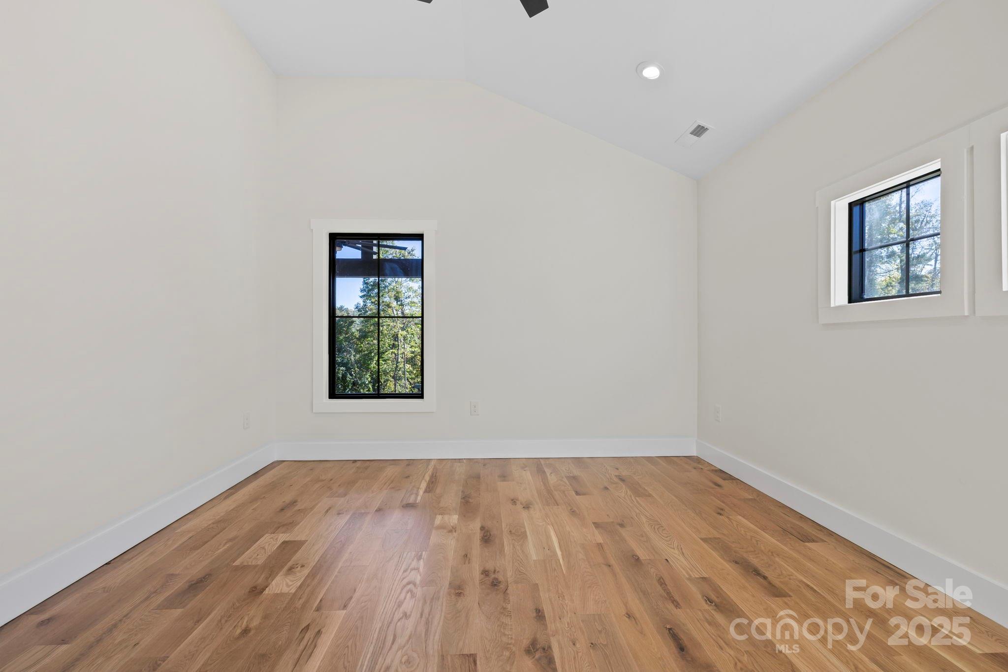 154 Osceola Road Hendersonville, NC 28739 - Photo 34 of 38 wooden floor in an empty room with a window