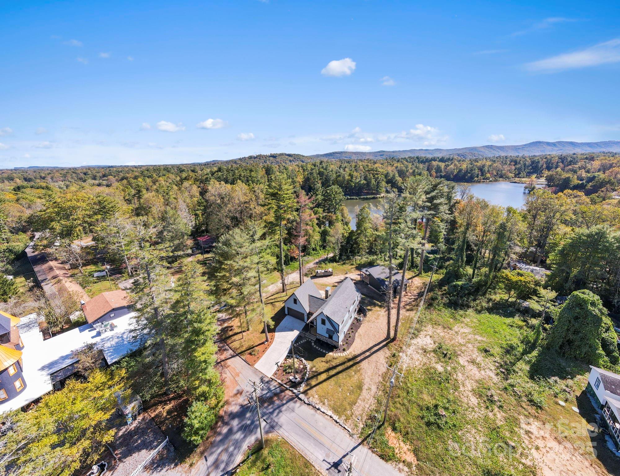 154 Osceola Road Hendersonville, NC 28739 - Photo 37 of 38 an aerial view of a house with a yard and lake view