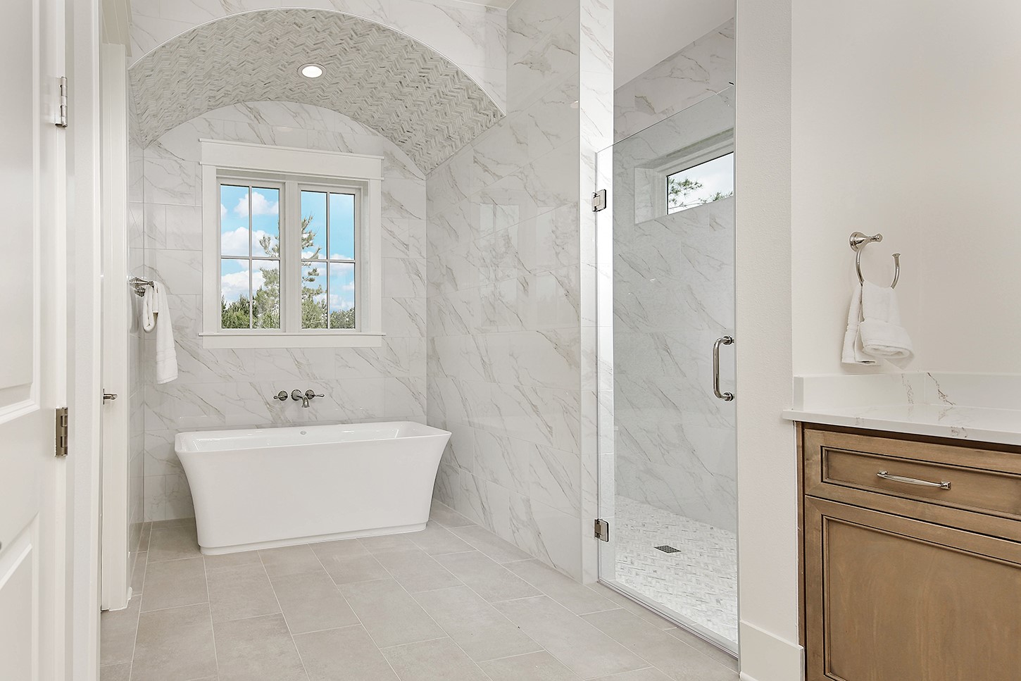 15728 Woodlife Road Willis, TX 77378 - Photo 22 of 36 Breathtaking soaking garden tub is accentuated by spectacular arched ceiling with custom tiled accents and walk-in shower with frameless glass door.